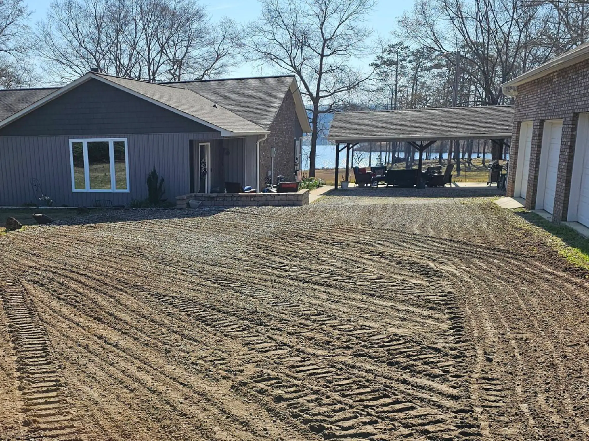 Before — graded dirt subgrade ready for gravel